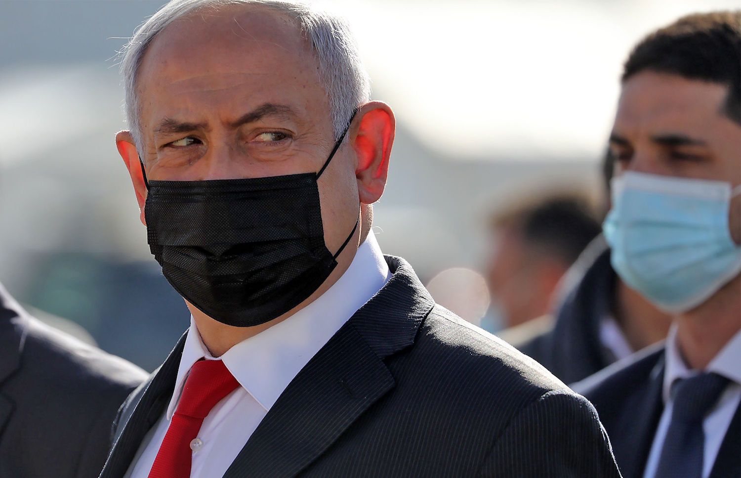 Israeli Prime Minister Benjamin Netanyahu attends a ceremony to mark the arrival of a plane of the international courier company DHL, carrying over 100,000 of doses of the first batch of Pfizer vaccines which landed at Ben Gurion Airport near Tel Aviv, on December 9, 2020. (AFP)