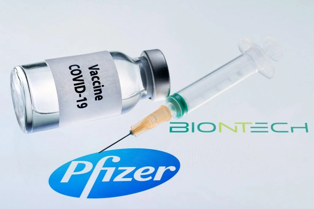 This illustration picture taken on November 23, 2020 shows a bottle reading “Vaccine Covid-19” and a syringe next to the Pfizer and Biontech logo. (File/AFP)