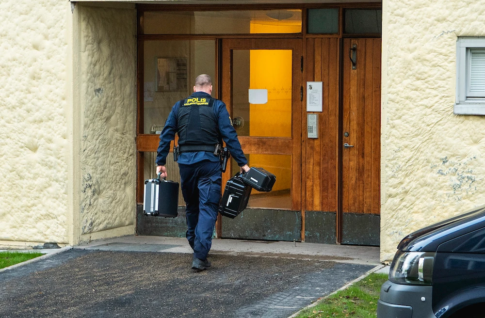 Police at the scene of an apartment where a woman is suspected of locking up her son, in Haninge, south of Stockholm, Dec. 1, 2020. (AP Photo)