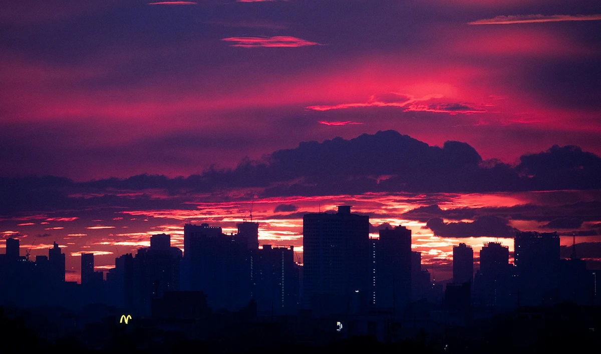 A silhouette of the skyline is pictured at sunset in Quezon City, Metro Manila, Philippines, November 27, 2020. (Reuters)