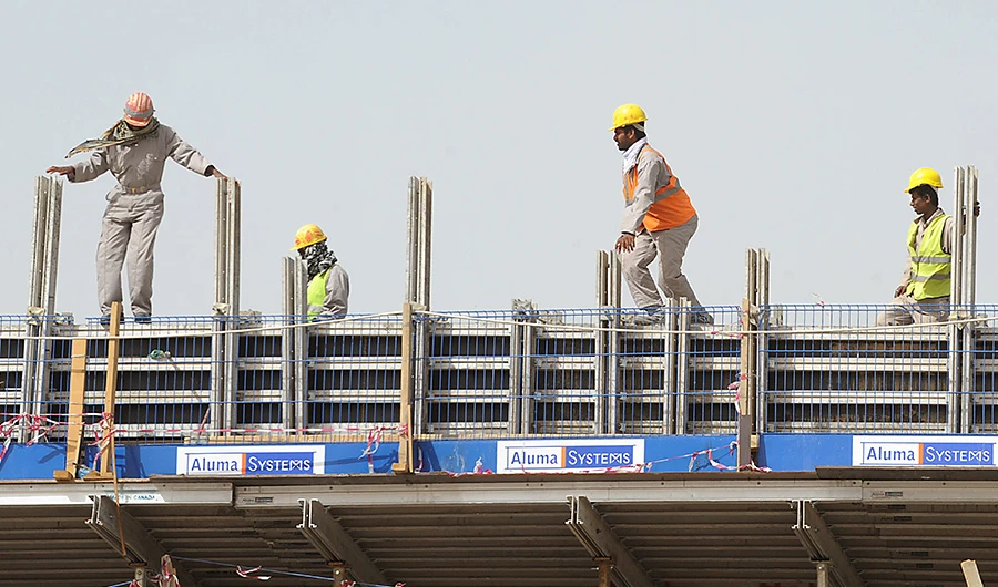 Asian labourers work on a flyover construction site in eastern Riyadh on April 7, 2013. (AFP)