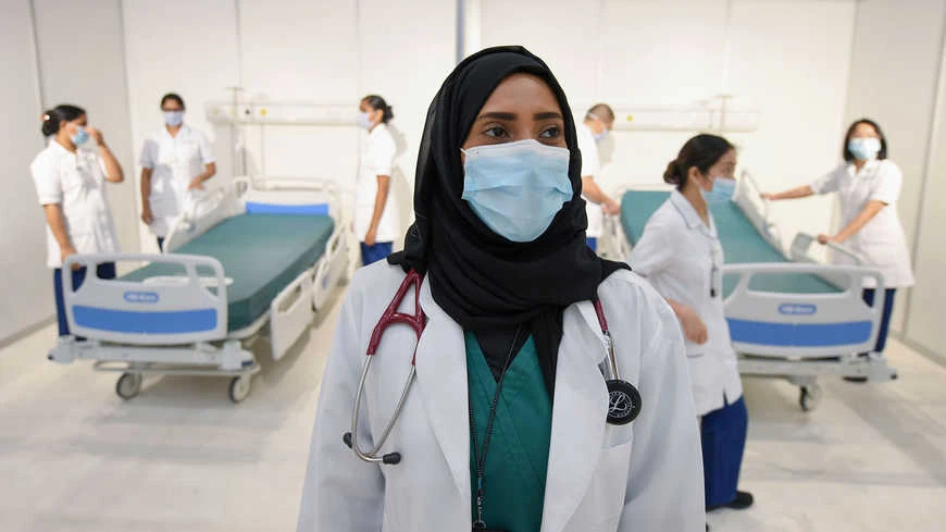 An Emirati doctor looks on as nurses prepare beds in a huge field hospital being built in Dubai, UAE. (File/AFP/Getty Images)