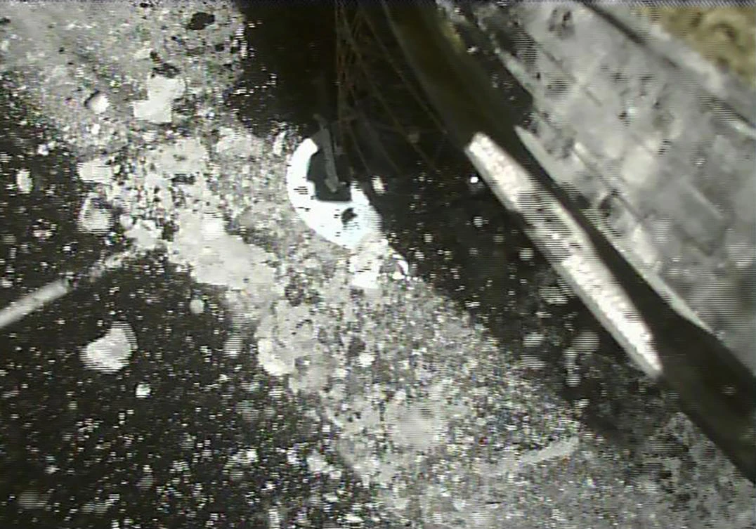 In this file image taken and released on July 11, 2019, by the Japan Aerospace Exploration Agency (JAXA), the Japanese Hayabusa2 spacecraft lands on an asteroid to collect samples. (AP)