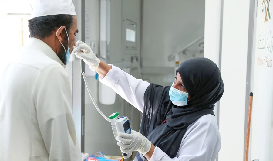 A Saudi nurse checks a patient's temperature at a mobile clinic catering for the residents of Ajyad Almasafi district in the holy city of Mecca. (AFP)