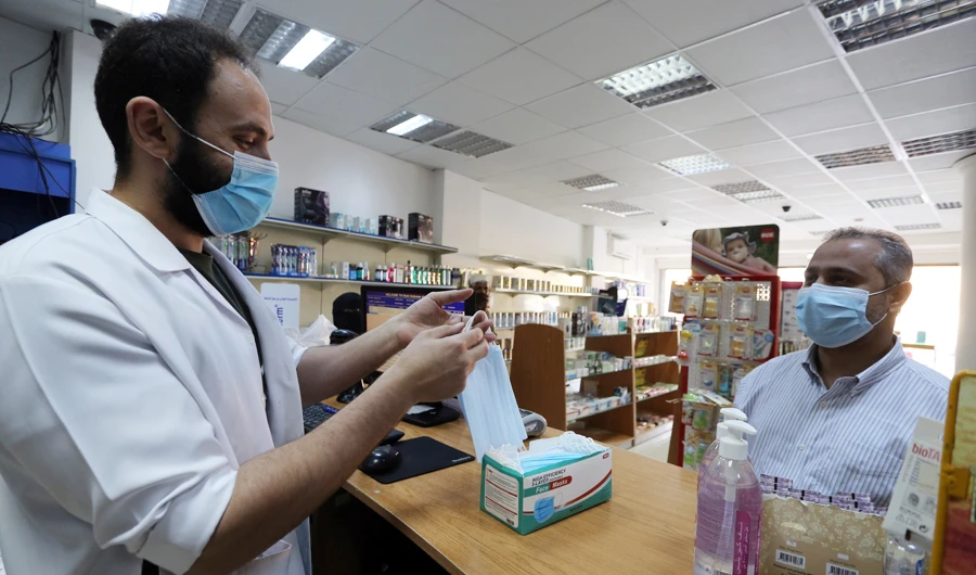 A man wearing a protective mask, buys masks from a pharmacy, after the government lifted coronavirus disease (COVID-19) lockdown restrictions, in Riyadh, Saudi Arabia July 5, 2020. (REUTERS)