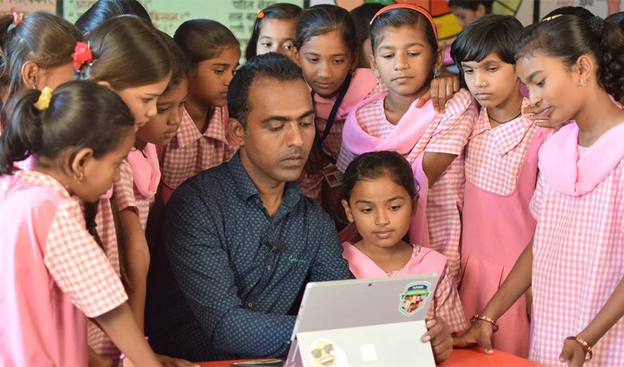 In this undated photo, Global Teacher Prize 2020 winner Ranjitsingh Disale with his students at a primary school in Paritewadi village, Solapur district, Maharashtra, India. (Supplied)