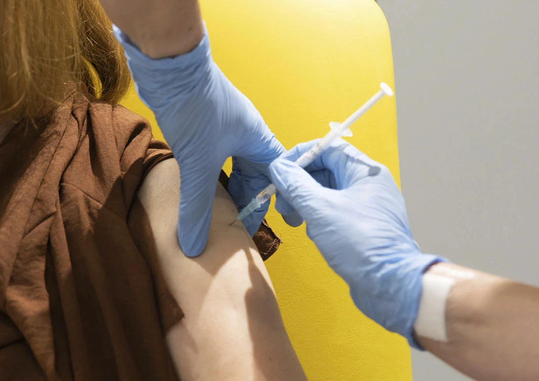 A volunteer is administered the coronavirus vaccine developed by AstraZeneca and Oxford University, in Oxford, England. (AP Photo)