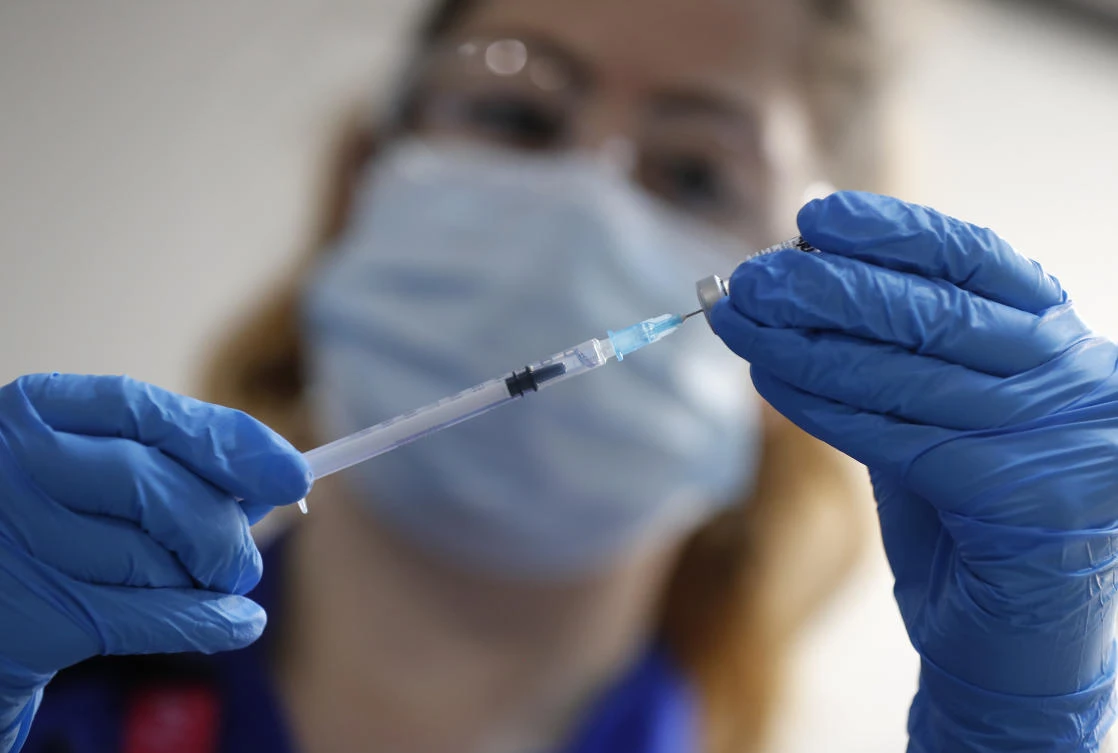 A nurse prepares a shot of the Pfizer-BioNTech COVID-19 vaccine at Guy's Hospital in London, Tuesday, Dec. 8, 2020, as the U.K. health authorities rolled out a national mass vaccination program. (AP Photo/Frank Augstein, Pool)