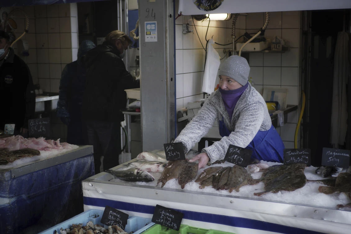 A fish seller arranges her stall in the market at the Port of Boulogne-sur-Mer, northern France, Dec. 10, 2020. (AP Photo)