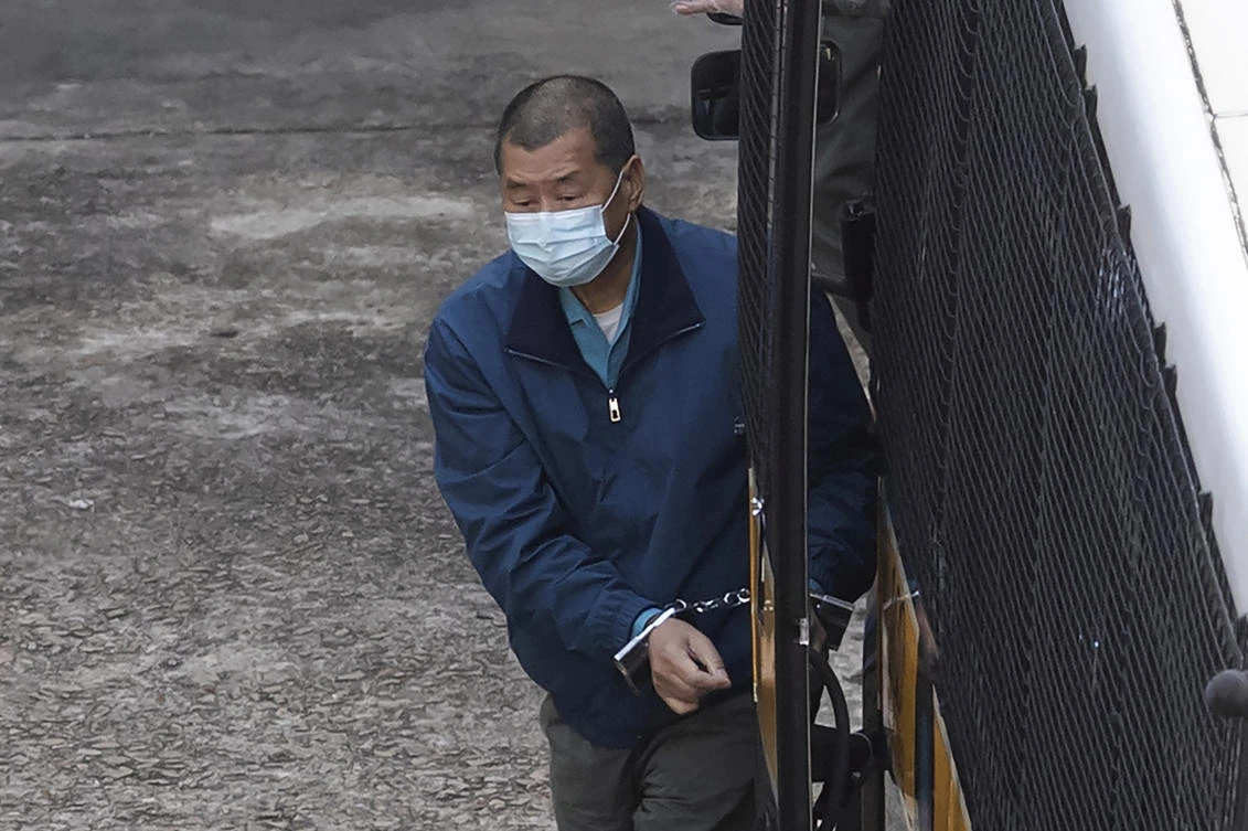 Pro-democracy media tycoon Jimmy Lai is escorted by Correctional Services officers to prison in Hong Kong, Dec. 3, 2020. (AP Photo)