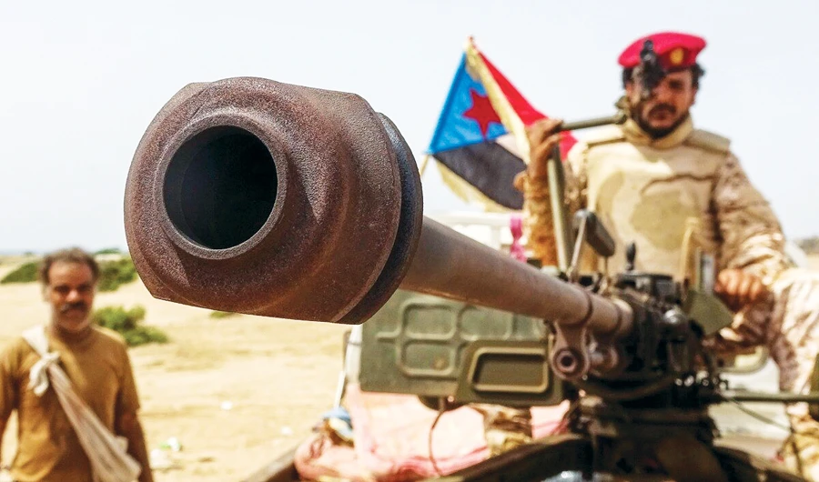A fighter loyal to Yemen’s separatist Southern Transitional Council (STC) holds the separatist flag in the southern Abyan province. (AFP)