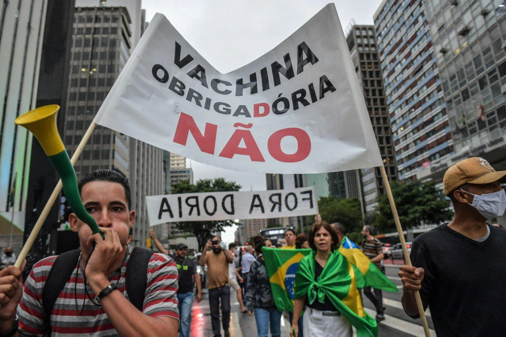 Demonstrators protest against Sao Paulo's governor Joao Doria and the vaccination with Chinese immunizer against COVID-19 coronavirus, CoronaVac in Sao Paulo, Brazil, on December 8, 2020. The Brazilian state of Sao Paulo will start vaccinating against COVID-19 with Chinese immunizer CoronaVac on January 25, which is on its last phase of study. (AFP / NELSON ALMEIDA)