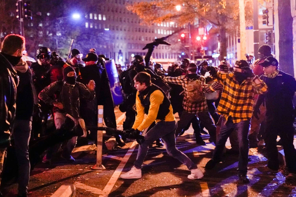 Members of the far-right group Proud Boys clash with counter protesters, in downtown Washington, D.C, on December 12, 2020. (REUTERS/Erin Scott)