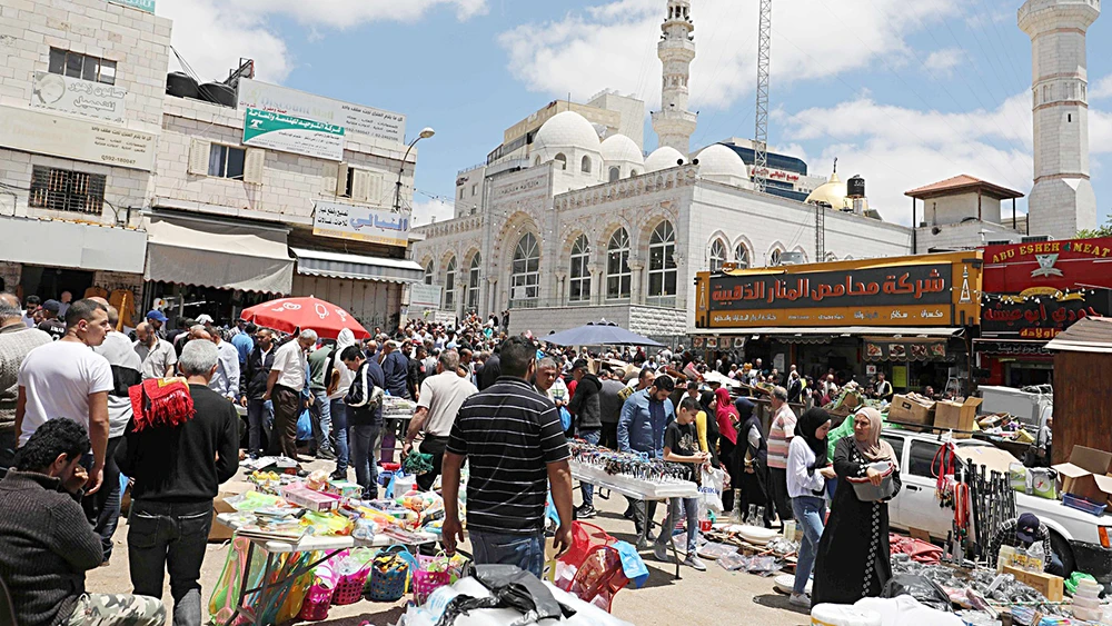 Palestinians at a market in the West Bank city of Ramallah. Israel allowed a Gaza-based company to market its products in West Bank markets, for the first time in 14 years. (AFP)