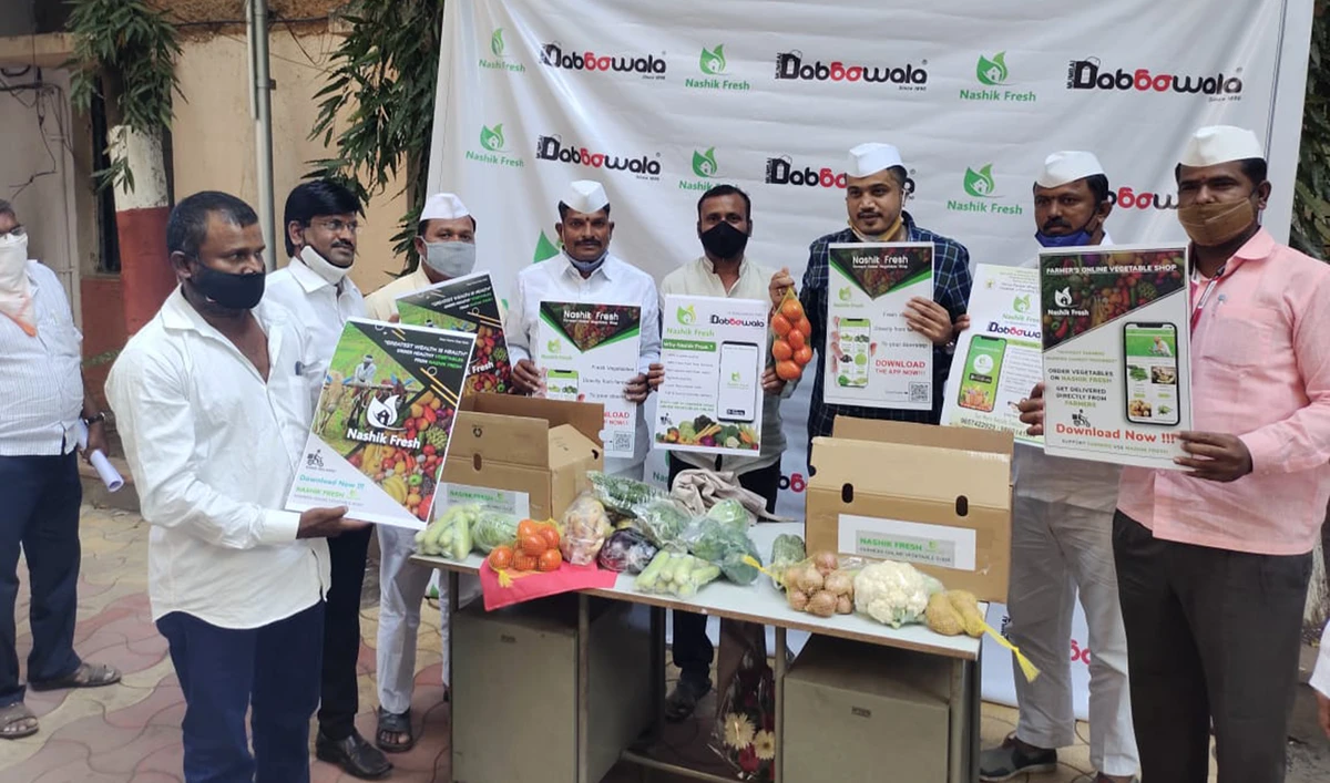 Representatives from the Mumbai dabbawalas network after signing an agreement with farmers groups to supply fresh vegetables to households. (Supplied)