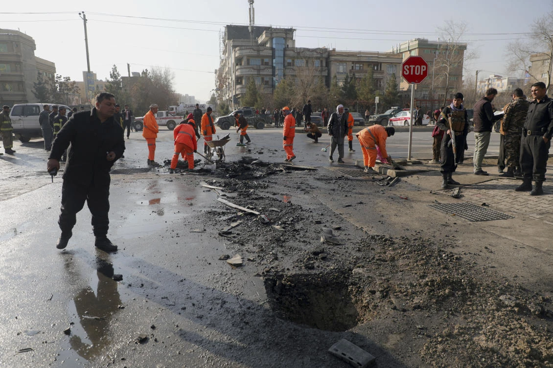 Afghan Municipality workers clean the remains of a vehicle after a bomb blast in Kabul, Afghanistan, Sunday, Dec. 13, 2020. A sticky bomb attached to an armored vehicle in northern Kabul killed a few, and wounded at least a few others, according to Ferdaws Faramarz, a spokesman for the Kabul police chief. No further details were immediately available. (AP)