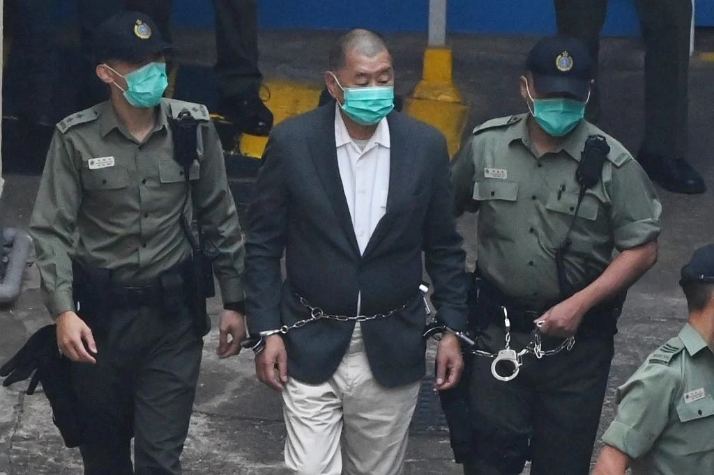 Hong Kong media tycoon Jimmy Lai, center, is led into a police van as he heads to court to be charged under the China-imposed national security law on Dec. 12, 2020. (AFP)