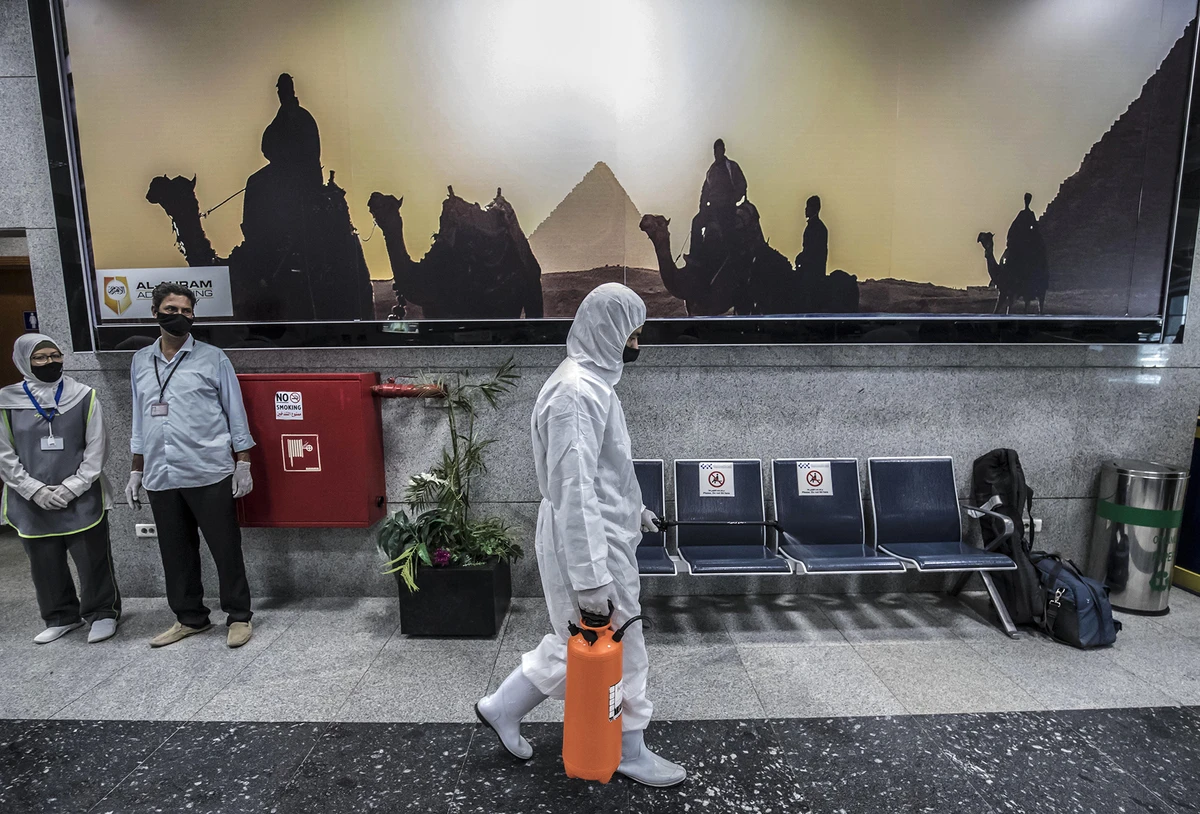 A worker wears protective gear as he sprays disinfectant at Hurghada International Airport in Hurghada, Egypt, June 18, 2020. (AFP)
