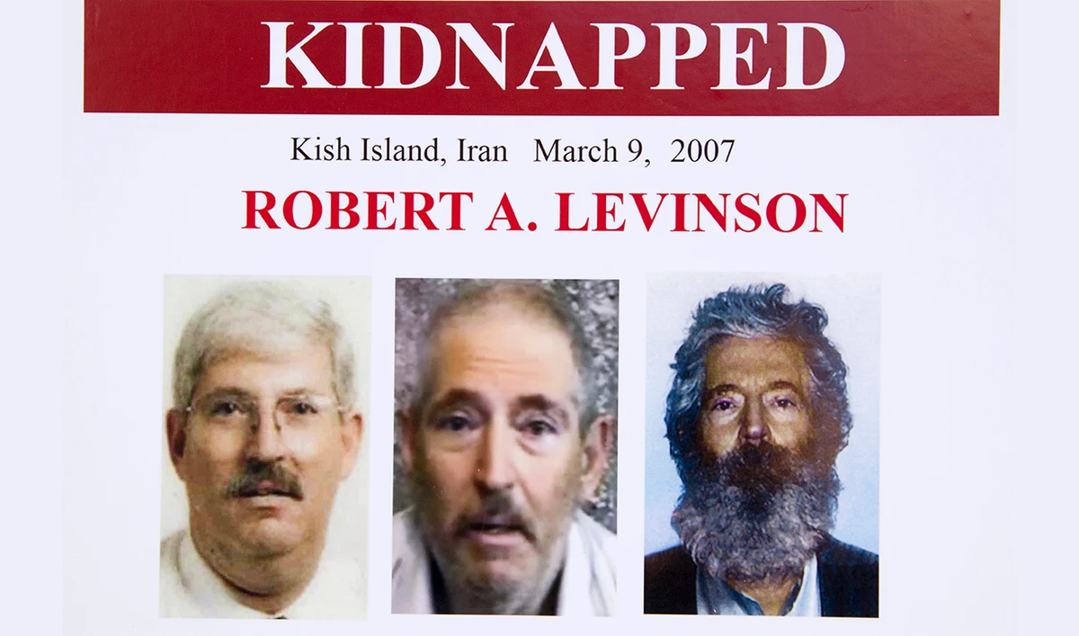 In this March 6, 2012, file photo, an FBI poster showing a composite image of former FBI agent Robert Levinson. At right, is a photo of how he would look like after five years in captivity, and an image, center, taken from the video, released by his kidnappers, and a picture before he was kidnapped, left, displayed during a news conference in Washington. (AP)