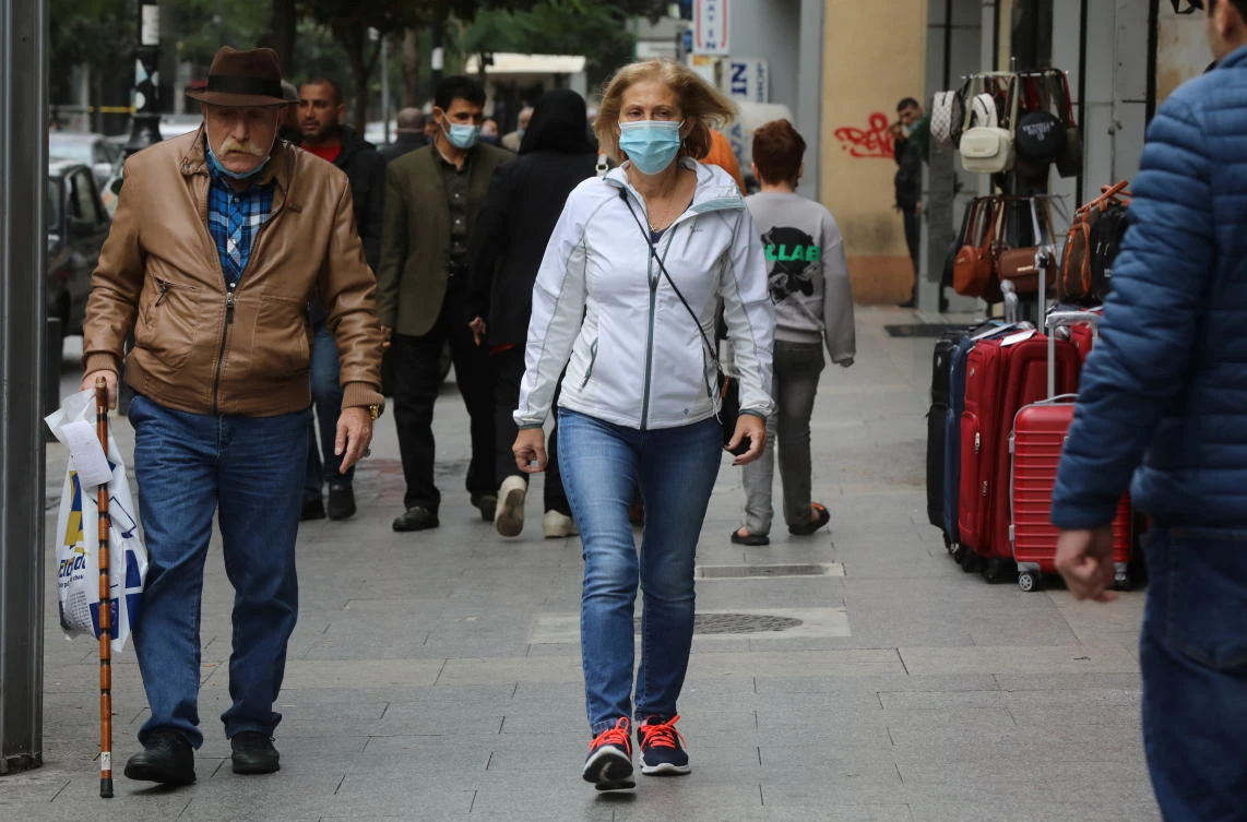 People wear face masks as they walk along a street in Beirut, Lebanon December 15, 2020. (Reuters)