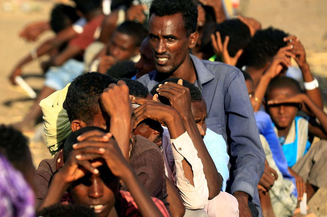 Ethiopians who fled the ongoing fighting in Tigray region, queue to receive food aid in the Hamdayet village, in eastern Kassala state, Sudan December 15, 2020. Picture taken December 15, 2020. (Reuters)