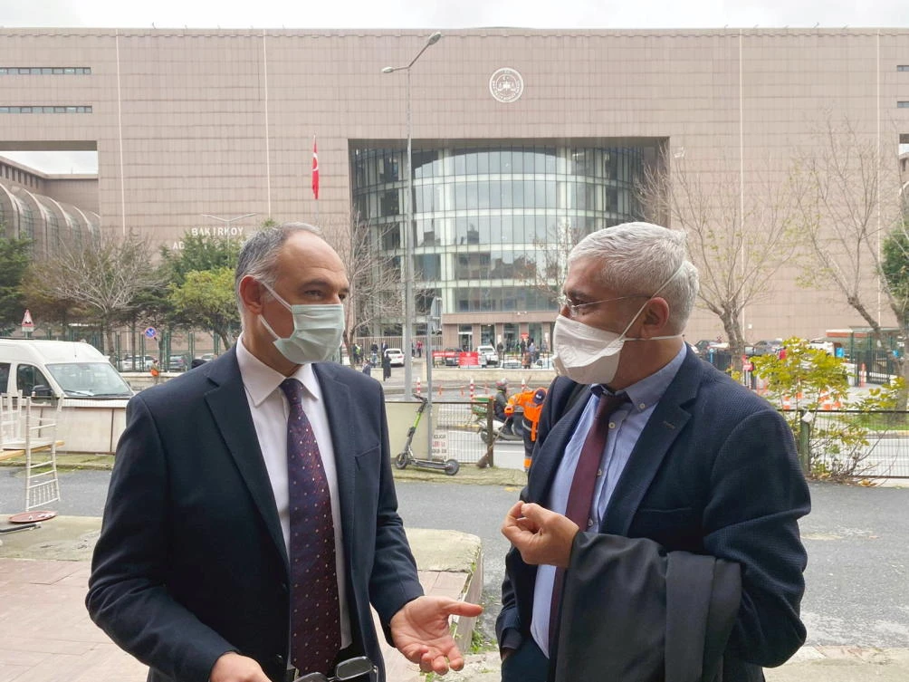 Turkish pilot Noyan Pasin chats with his lawyer Erem Yucel before a hearing of seven people charged over their alleged involvement in former Nissan boss Carlos Ghosn's escape from Japan to Lebanon via Istanbul, outside a courthouse in Istanbul, Turkey December 17, 2020. (Reuters)