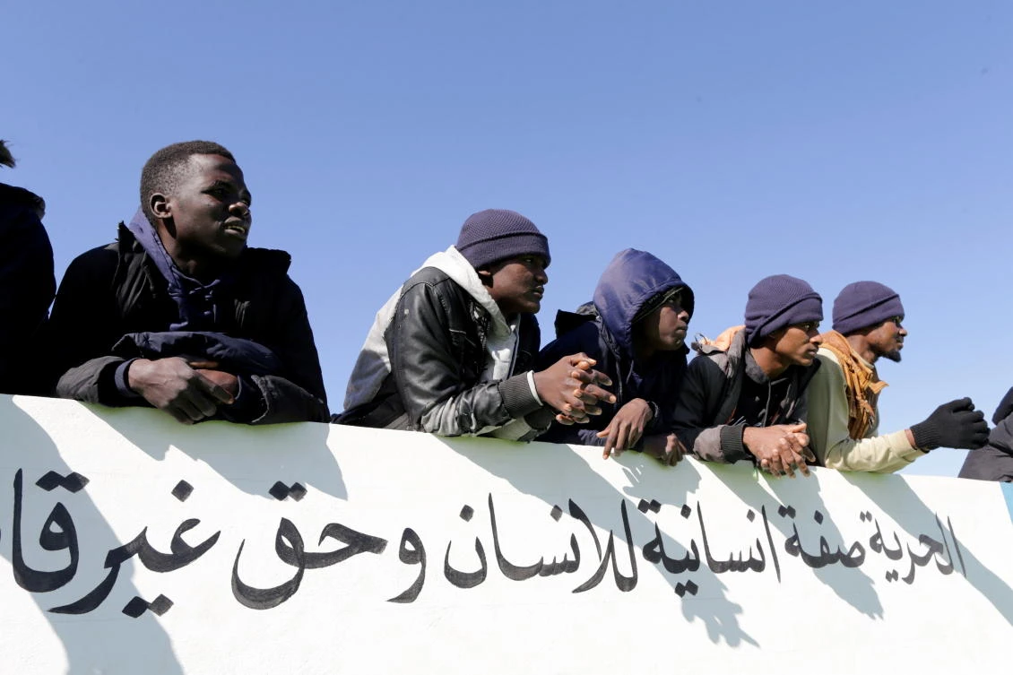 Migrants watch a football match inside the headquarters of immigration in Benghazi, Libya December 5, 2020. Picture taken December 5, 2020. (Reuters)