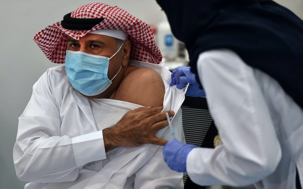 The first Saudi citizen to receive the Pfizer-BioNTech COVID-19 vaccine prepares for the shot in Riyadh, Saudi Arabia. (File/AFP)