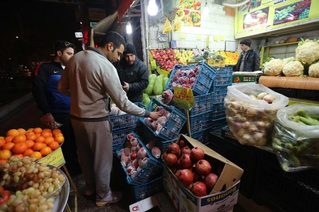 Iranian man arranges pomegranates at his shop in downtown Tehran on Dec. 21, 2014, in preparation for the annual festival of Yalda. (File/AFP)
