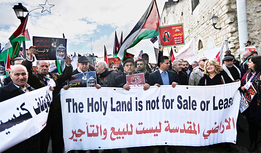 Palestinian demonstrators protest against the selling of church land to Israelis, in the West Bank city of Bethlehem. An unknown deal to turn the land into a parking lot is causing concern for the Palestinian leadership. (AP/File)