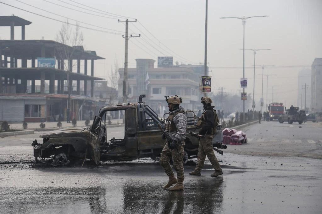 Members of the Afghan security forces stand at the site of an attack, in Kabul on December 20, 2020. (AFP)