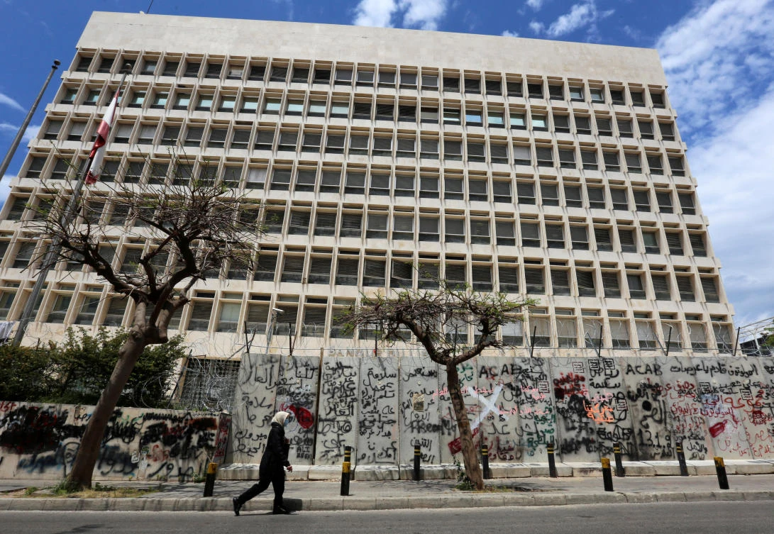 A woman wearing a protective mask walks past Central Bank building as Lebanon extends a shutdown to curb the spread of the coronavirus disease (COVID-19) in Beirut, Lebanon, May 5, 2020. (Reuters)