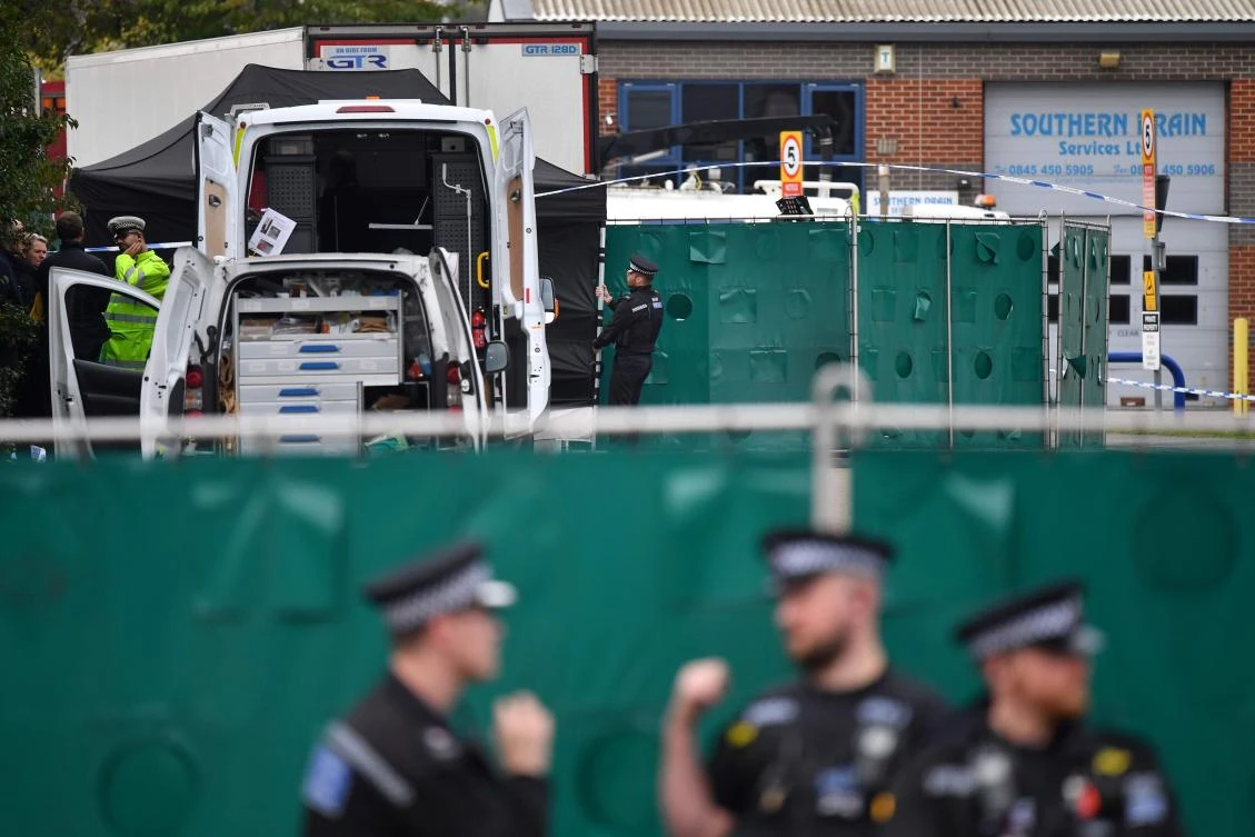 In this file photo taken on October 23, 2019 British Police officers work near a lorry, believed to have originated from Bulgaria, and found to be containing 39 dead bodies, inside a police cordon at Waterglade Industrial Park in Grays, east of London, on October 23, 2019. (AFP)