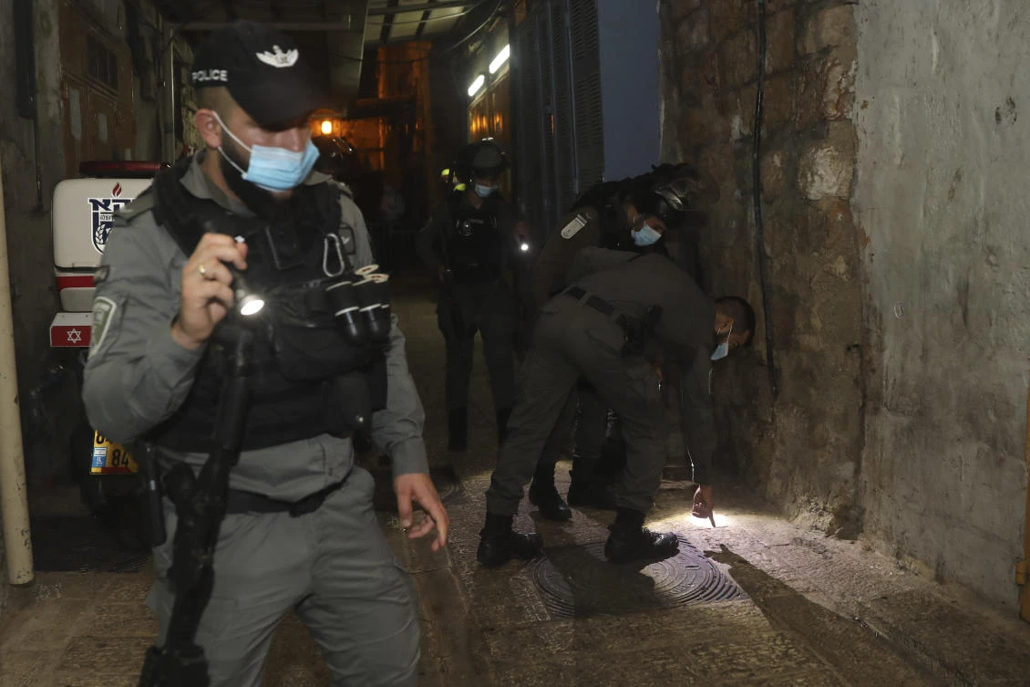 Israeli border police officers inspect the scene of an attack in the Old City of Jerusalem, Monday, Dec. 21, 2020. Israeli police said Monday they shot a Palestinian attacker who opened fire at a group of officers in Jerusalem's Old City. (AP)