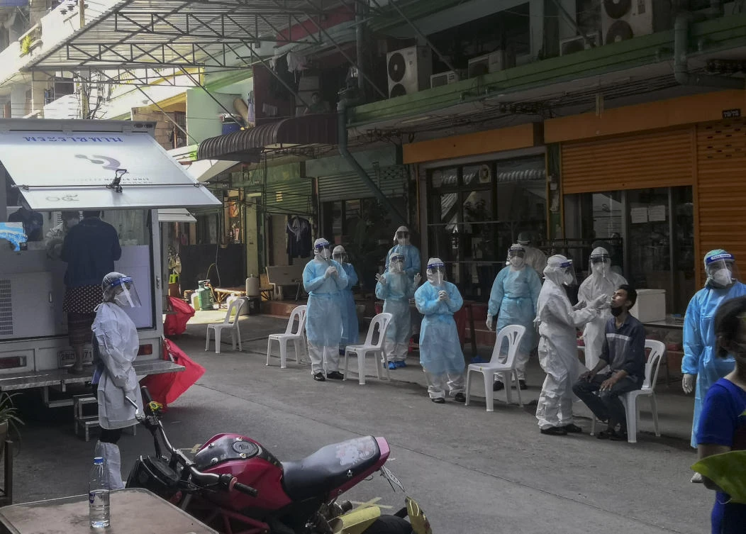 A health worker in protective clothing collects nasal swab sample from a man to test for COVID-19 in Samut Sakhon, South of Bangkok, Thailand, Sunday, Dec. 20, 2020. (AP)