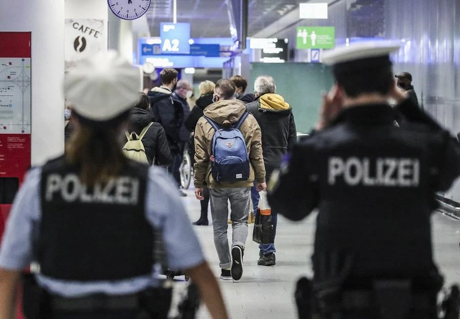 Police watch passengers arriving at Frankfurt International Airport in Frankfurt am Main, western Germany, on December 21, 2020. (File/AFP)