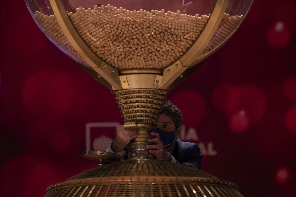 A worker prepares the numbered lottery balls at Madrid’s Teatro Real opera house during Spain’s bumper Christmas lottery draw known as El Gordo, or The Fat One, in Madrid, Spain, Tuesday, Dec. 22, 2020. (AP)