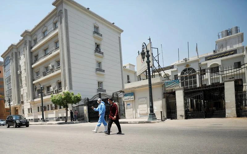 Members of medical team walk in front of the Institute of Research for Tropical Medicine amid concerns about the spread of the coronavirus disease (COVID-19), in Cairo, in Egypt. (Reuters/File)