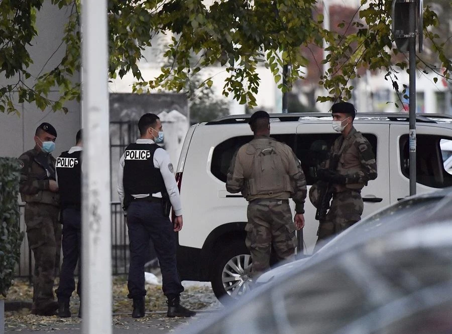 Security and emergency personnel are on October 31, 2020 in Lyon at the scene where an attacker armed with a sawn-off shotgun wounded an Orthodox priest in a shooting before fleeing, said a police source. (File/AFP)
