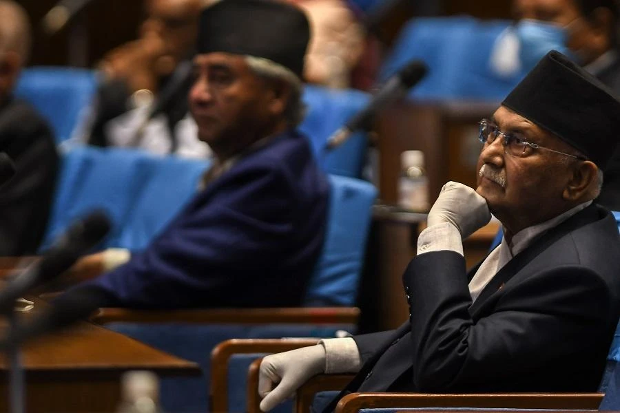 Nepal's Prime minister KP Sharma Oli (R) listens as Finance Minister Yubaraj Khatiwada (not pictured) announces the budget for the 2020/2021 fiscal year, in Kathmandu on May 28, 2020. (File/AFP)