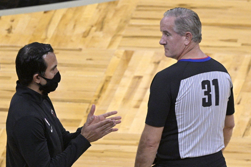 Miami Heat coach Erik Spoelstra, left, argues with official Scott Wall during a timeout in the first half of the team's NBA basketball game against the Orlando Magic, on Dec. 23, 2020, in Orlando, Florida. (AP Photo/Phelan M. Ebenhack)