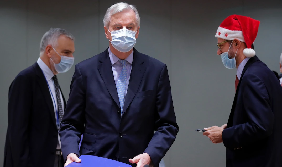 European Union's chief Brexit negotiator Michel Barnier holds the pages of Brexit trade deal in Brussels on Dec. 25, 2020. (Reuters)