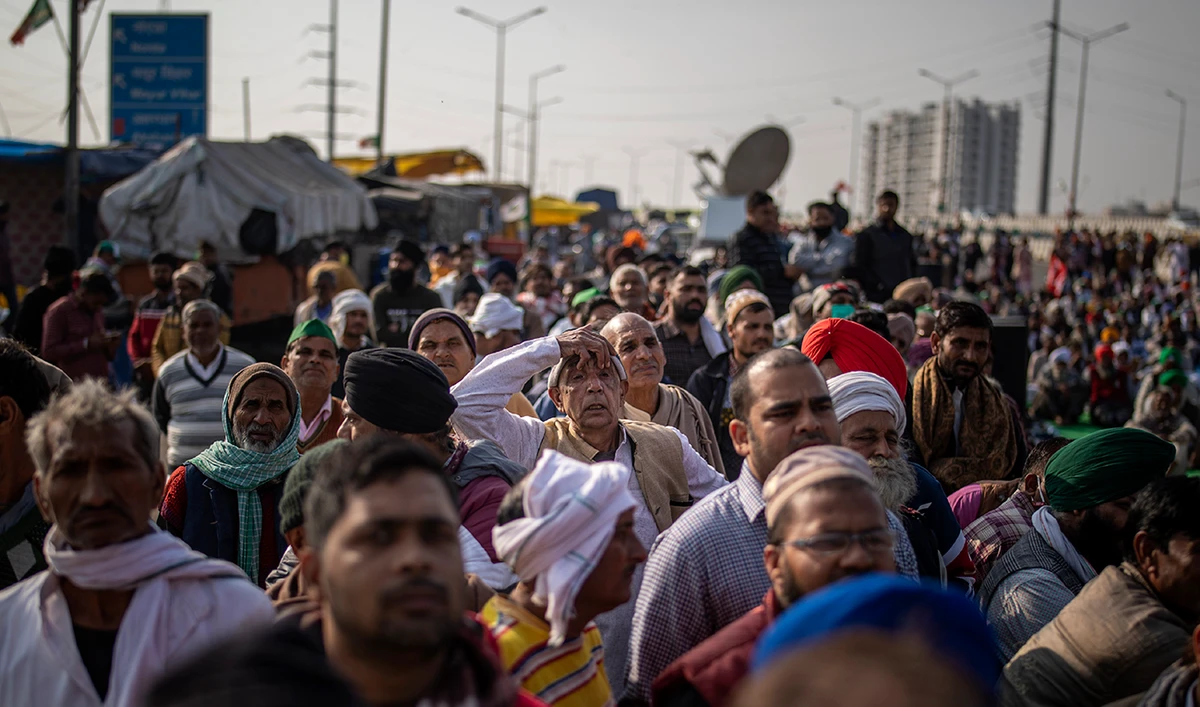Farmers listen to a speaker as they block a major highway in a protest against new farm laws at the Delhi-Uttar Pradesh state border, India, Friday, Dec. 25, 2020. (AP)