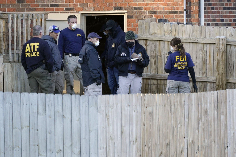 FBI and ATF agents search the basement of a home of a bombing suspect on Dec. 26, 2020, in Nashville, Tennessee. (AP Photo/Mark Humphrey)