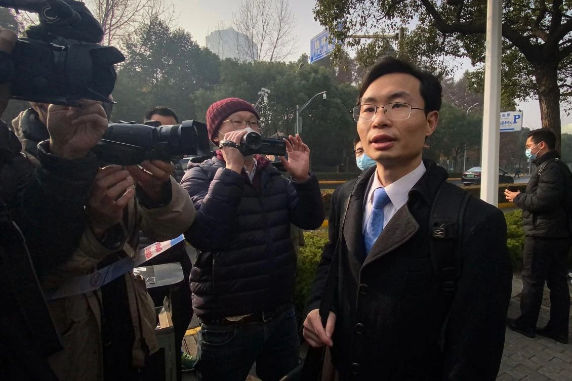 Lawyer Zhang Keke, representing Chinese citizen journalist Zhang Zhan who reported on Wuhan’s Covid-19 outbreak and placed under detention since May, speaks to the media outside the Shanghai Pudong New District People’s Court where Zhang Zhan is set for trial in Shanghai on Dec. 28, 2020. (AFP)