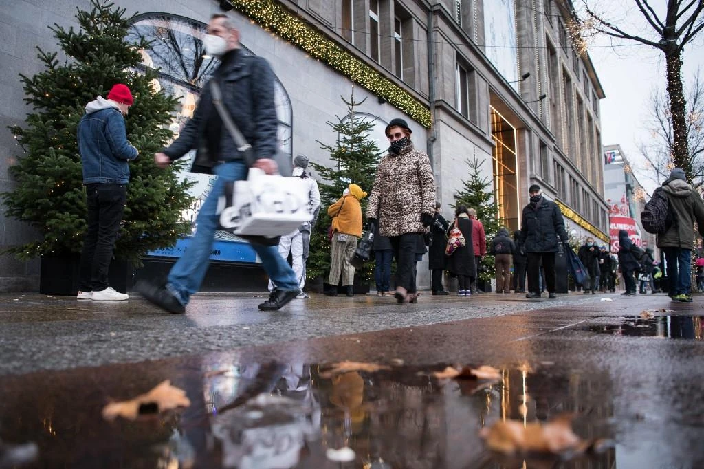 People queue in front of the KaDeWe (Kaufhaus des Westens) department store in Berlin to access the food department that remains open on Dec. 23, 2020. (File/AFP)