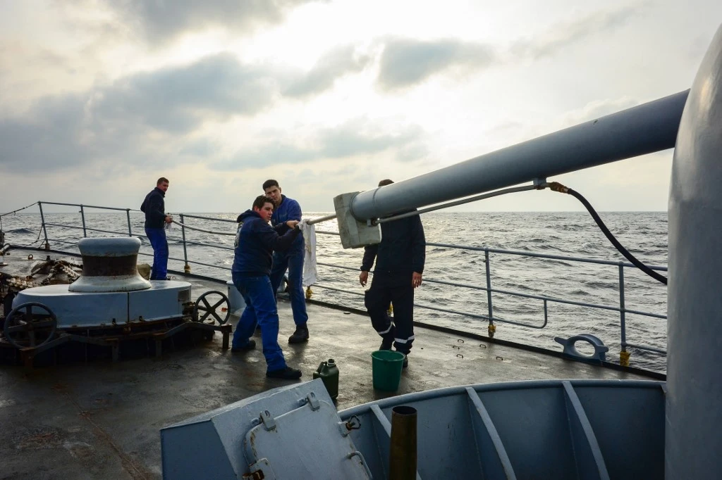 Sailors clean the barrel of a gun aboard a ship at an undisclosed location in the Black Sea. (File/AFP)