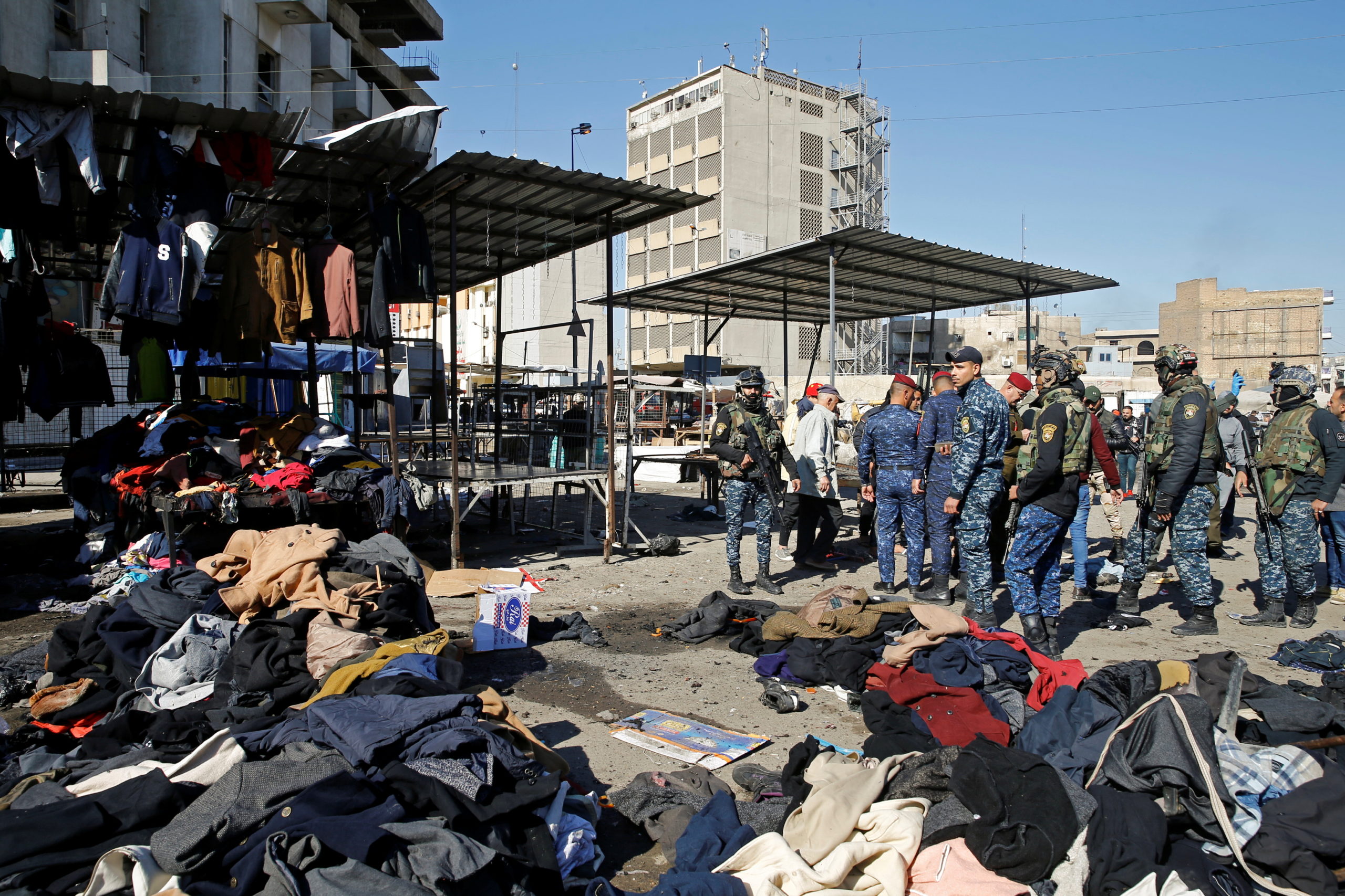 Members of the Iraqi security forces gather at the site of a twin suicide bombing attack in a central market in Baghdad, Iraq, Jan. 21, 2021. (Reuters)