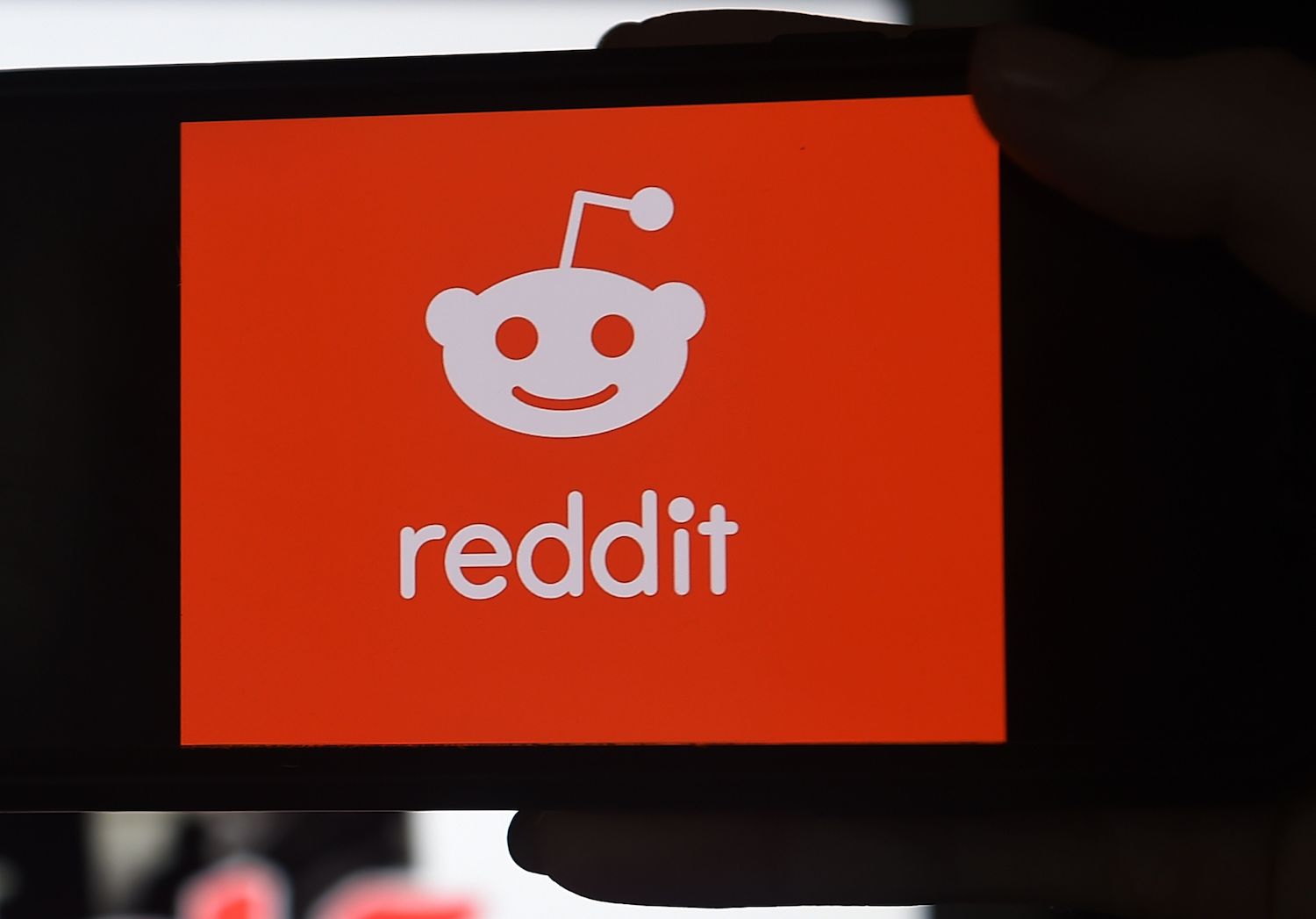 This photo illustration shows the logo of Reddit on a mobile phone in Arlington, Virginia on January 29, 2021. (AFP)