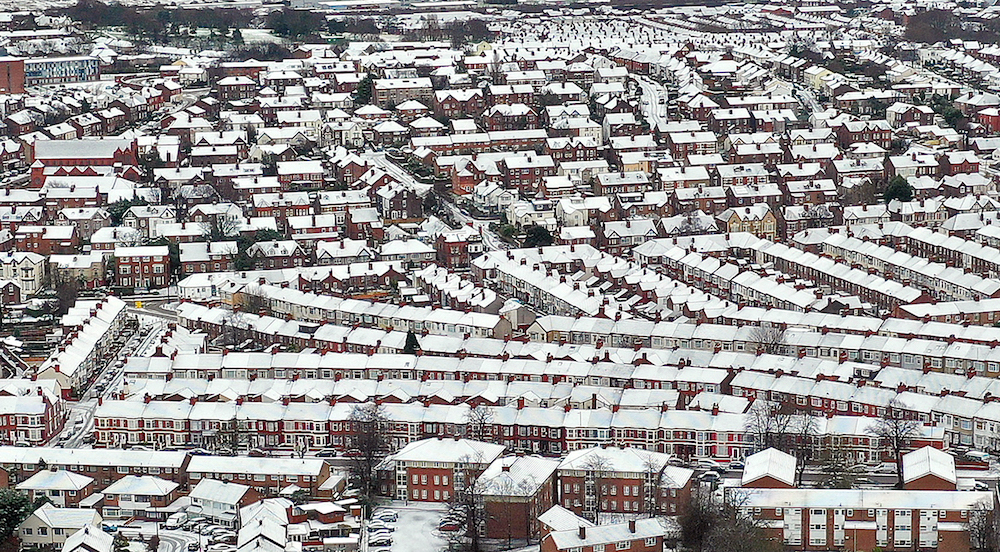 An aerial view shows the snow-covered rooftops of houses in Birkenhead, north west England on January 23, 2021, as a Met office yellow weather warning for snow and ice covers much of the UK early on Saturday. (AFP/File Photo)